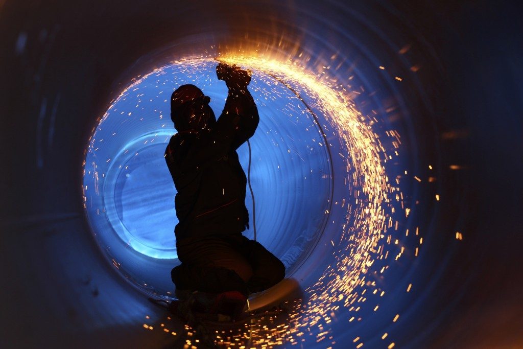 Worker welding inside a pipe