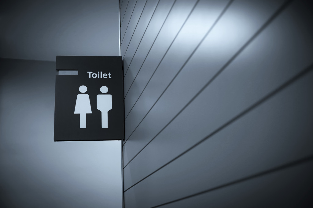 A black toilet sign implying gender-neutrality