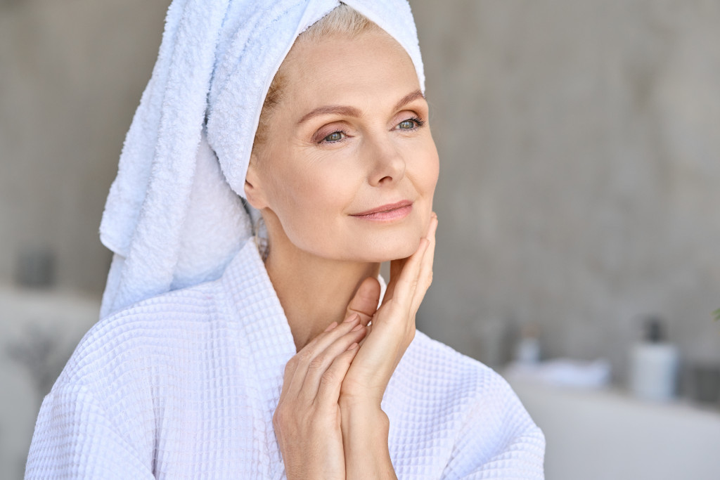 a senior woman looking fresh and clean wearing a bathrobe